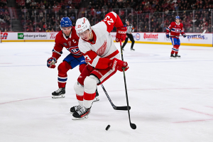 Dec. 2, 2023 ~ Detroit Red Wings left wing Lucas Raymond (23) defends the puck against Montreal Canadiens center Nick Suzuki (14) during the first period at Bell Centre. Photo: David Kirouac ~ USA TODAY Sports