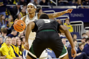 Dec. 16, 2023 ~ Michigan Wolverines guard Dug McDaniel (0) dribbles defended by Eastern Michigan Eagles guard Tyson Acuff (5) in the first half at Crisler Center. Photo: Rick Osentoski ~ USA TODAY Sports