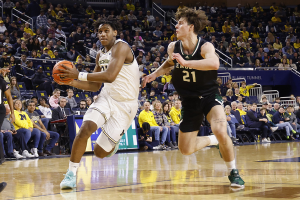 Dec. 16, 2023 ~ Michigan Wolverines forward Tarris Reed Jr. (32) dribbles on Eastern Michigan Eagles center Cyril Martynov (21) in the first half at Crisler Center. Photo: Rick Osentoski ~ USA TODAY Sports