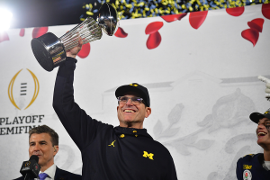 Jan. 1, 2024 ~ Michigan Wolverines head coach Jim Harbaugh celebrates with the trophy on the podium after defeating the Alabama Crimson Tide in the 2024 Rose Bowl college football playoff semifinal game at Rose Bowl. Photo: Gary A. Vasquez ~ USA TODAY Sports