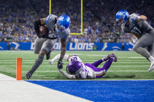 Jan. 7, 2024 ~ Detroit Lions running back Jahmyr Gibbs runs for a 3-yard touchdown against Minnesota Vikings defender Camryn Bynum during the first quarter at Ford Field in Detroit. Photo: David Rodriguez Munoz ~ USA TODAY NETWORK