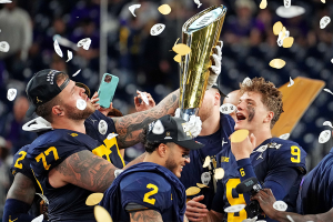 Jan. 8, 2024 ~ Michigan Wolverines offensive lineman Trevor Keegan (77) and quarterback J.J. McCarthy (9) celebrate with CFP National Championship trophy after defeating the Washington Huskies in the 2024 College Football Playoff national championship game at NRG Stadium. Photo: Kirby Lee- ~ USA TODAY Sports