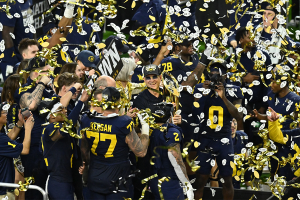 Jan. 8, 2024 ~ Michigan Wolverines head coach Jim Harbaugh holds the National Championship Trophy as he celebrates after winning 2024 College Football Playoff national championship game against the Washington Huskies at NRG Stadium. Photo: Maria Lysaker ~ USA TODAY Sports