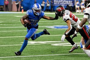 Jan 21, 2024 ~ Detroit, Michigan, USA; Detroit Lions running back Jahmyr Gibbs (26) runs with the ball against Tampa Bay Buccaneers cornerback Zyon McCollum (27) during the second half in a 2024 NFC divisional round game at Ford Field. Photo: Lon Horwedel ~ USA TODAY Sports