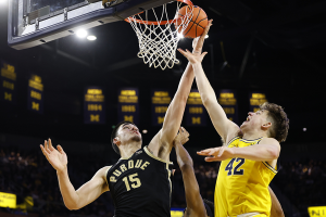 Feb 25, 2024 ~ Purdue Boilermakers center Zach Edey grabs the rebound over Michigan Wolverines forward Will Tschetter in the second half at Crisler Center. Photo: Rick Osentoski ~ USA TODAY Sports