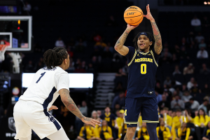 March 13, 2024 ~ Michigan Wolverines guard Dug McDaniel shoots as Penn State Nittany Lions guard Ace Baldwin Jr. defends during the first half at Target Center. Photo: Matt Krohn ~ USA TODAY Sports