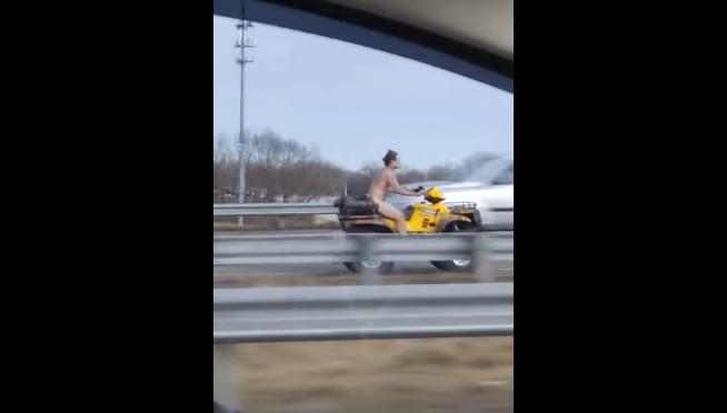 Naked guy rides ATV down highway