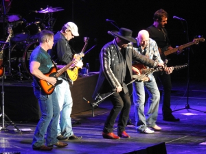Eddie Montgomery and Montgomery Gentry band members on stage.