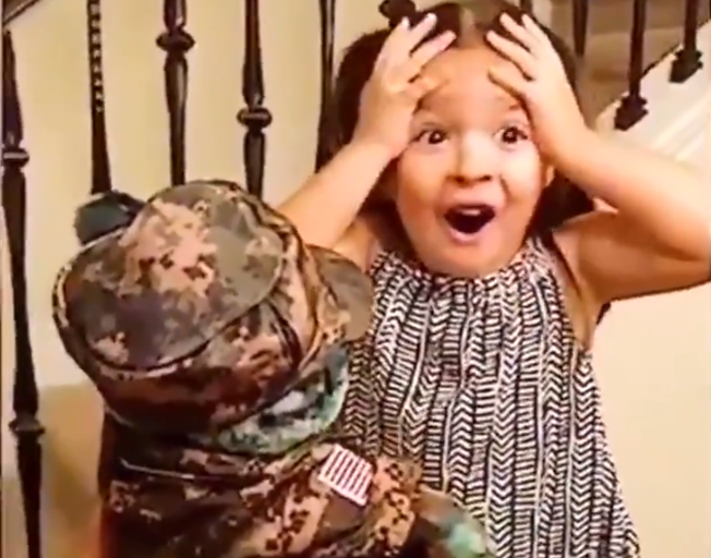 Little girl reacting to dad's voice from teddy bear