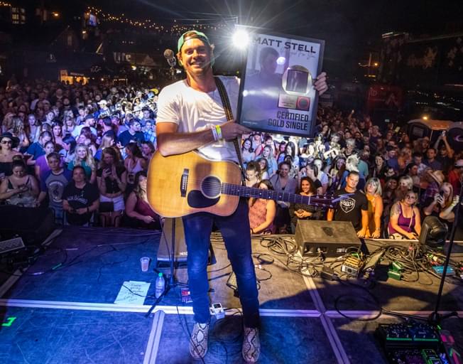 Matt Stell on stage at Whiskey Jam in Nashville holding plaque. (Photo courtesy of SOny Music Nashville/Credit: Alan Poizner)