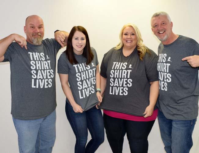 (L-R) B104 Staff members Buck Stevens, Dana Bell, Faith Rinker & Dan Westhoff wearing "This Shirt Saves Lives" St. Jude T-Shirts