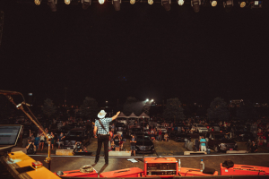Brad Paisley on stage at a drive-in concert event.