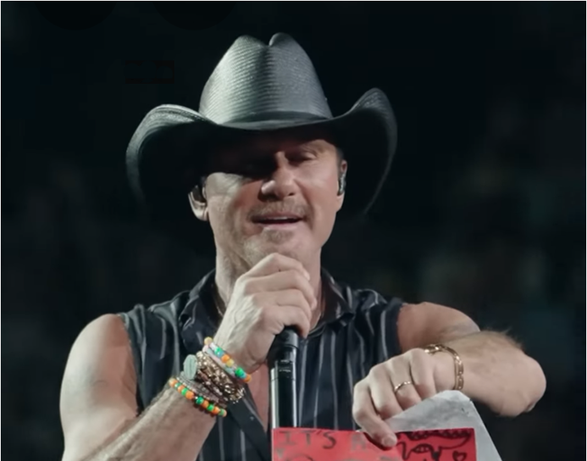 Watch: Tim McGraw Grants Fan’s Wish by Assisting with Baby Gender Reveal Onstage: “Tim or Faith?”