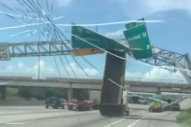 Watch This Dump Truck Leave Its Bucket Up and Destroy A Highway Sign in Texas