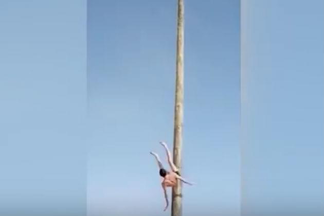 Watch This Guy Fall From the Top of a 23-Foot Pole [VIDEO]