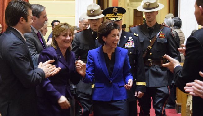 Gov. Gina Raimondo is greeted by lawmakers as she enters the House chamber to deliver her first budget. Photo by Steve Klamkin WPRO News
