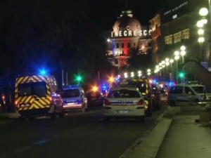 In this video grab taken Thursday July 14, 2016, ambulances and Police cars are seen after a truck drove on to the sidewalk and plowed through a crowd of revelers who’d gathered to watch the fireworks in the French resort city of Nice. officials and eyewitnesses described as a deliberate attack. There appeared to be many casualties. (BFMTV via AP)