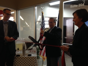 Lt. Governor Kim Reynolds looks on as Congressman David Young cuts the ribbon to officially open his new Des Moines Constituent Services Office. 