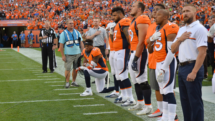 Denver LB Brandon Marshall, Kap’s college teammate, takes a knee during anthem