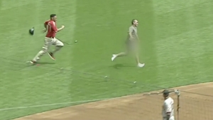 Security guard levels streaker on infield dirt during Giants-Brewers game
