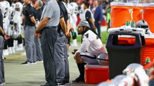 Marshawn Lynch photographed sitting during National Anthem