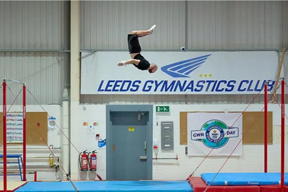 Gymnast back flips 19 feet, 8.2 inches between bars for Guinness record
