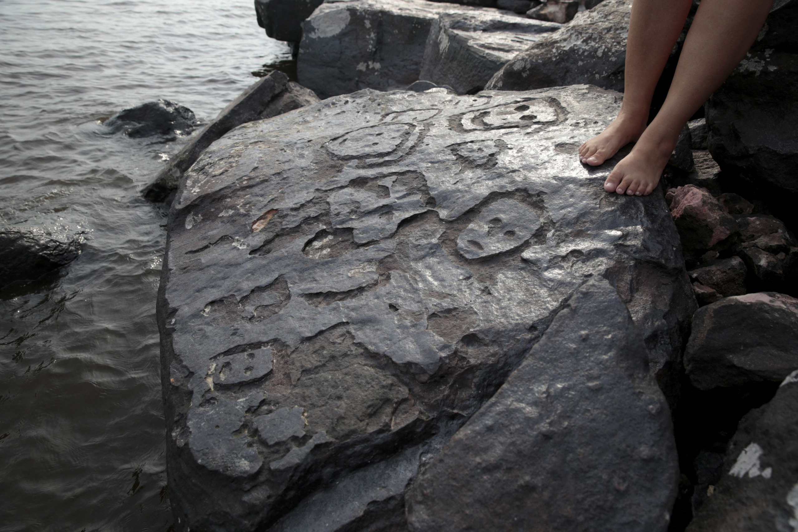 Ancient face carvings exposed as Amazon water level drops to record lows