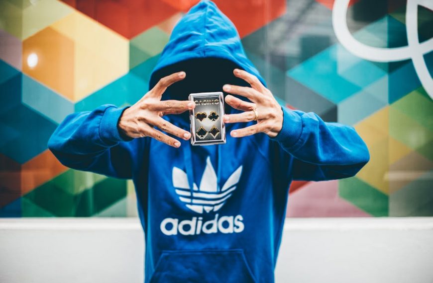 Man in Blue Adidas Hoodie Doing Magic Trick