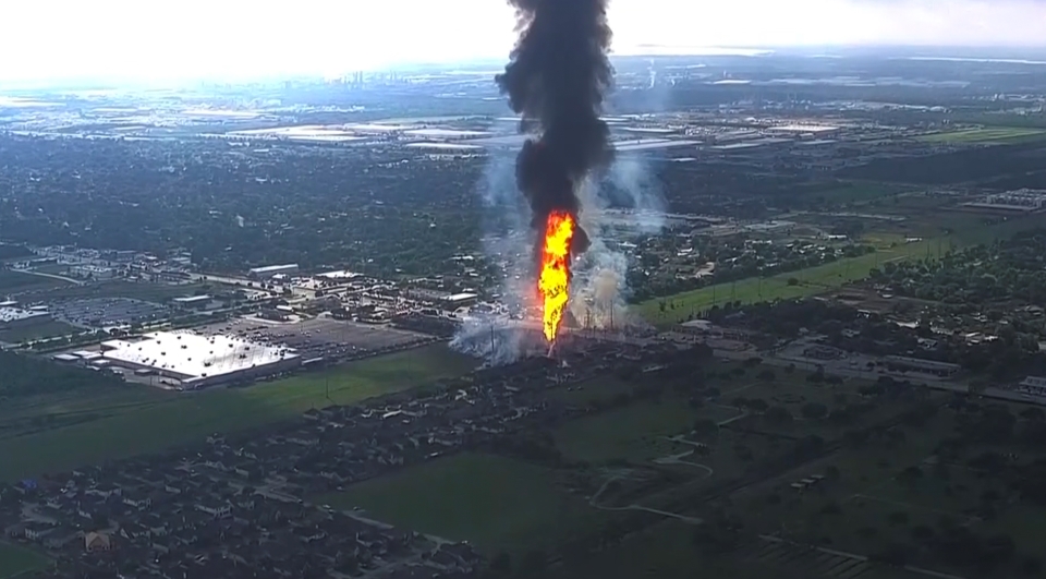 A pipeline explosion is shooting a towering pillar of flame over a Houston suburb