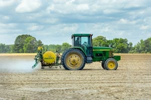 Green and Yellow Tractor on Dirt