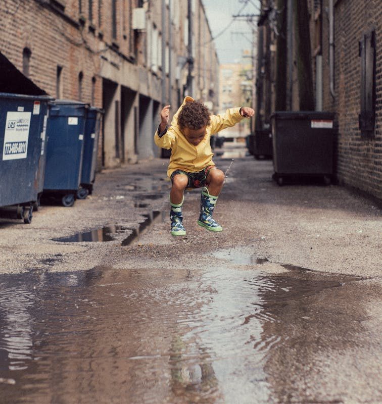 Child Jumping Into Body of Water