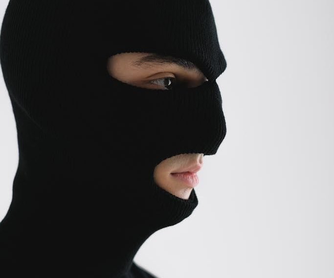 Close-Up Shot of a Person Wearing a Robber Mask