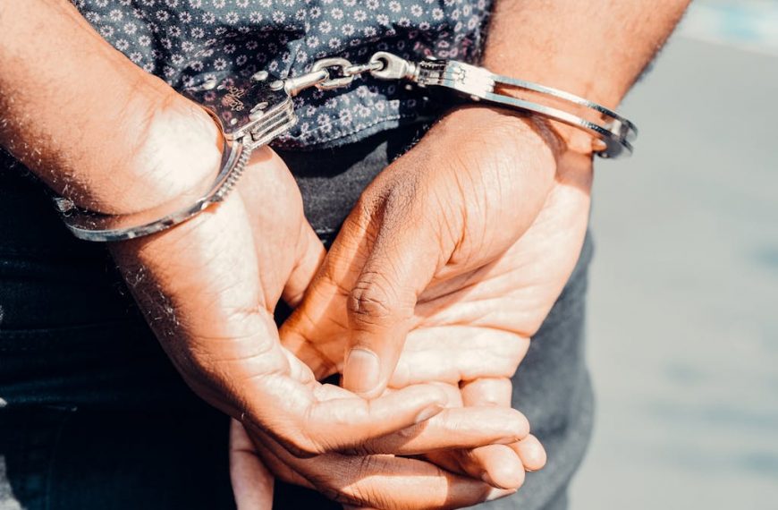 Close Up Photography of Person in Handcuffs